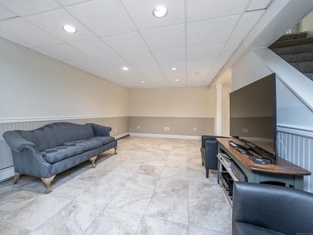 living area featuring wainscoting, a baseboard heating unit, a paneled ceiling, and recessed lighting