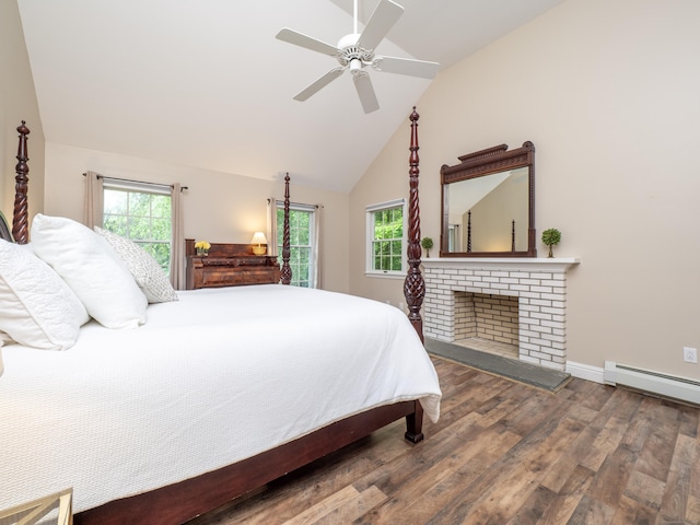 bedroom with wood finished floors, multiple windows, a baseboard radiator, and high vaulted ceiling