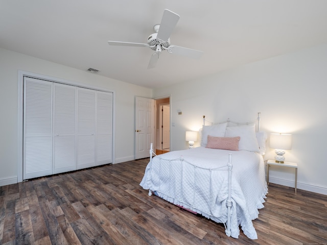 bedroom featuring wood finished floors, a closet, baseboards, and ceiling fan