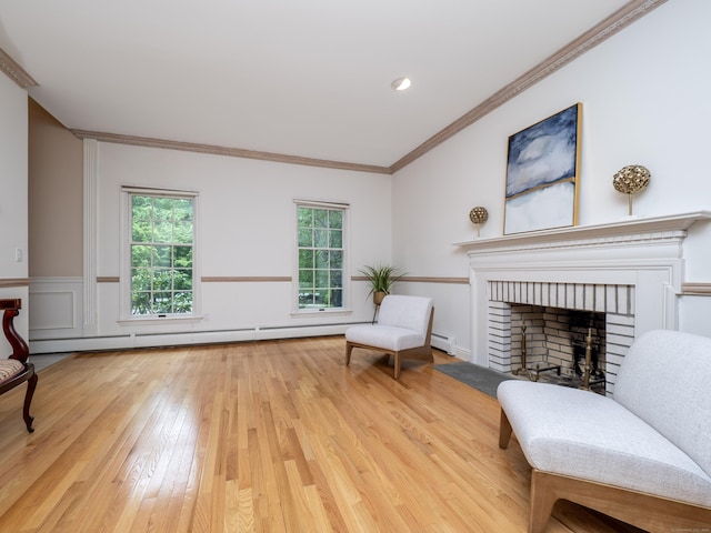 sitting room featuring wood-type flooring, a baseboard radiator, crown molding, and a fireplace