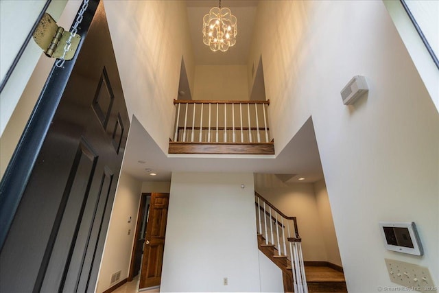 4665 Black Rock Tpke, Fairfield, CT 06824 - stairway featuring a high ceiling, a chandelier, and baseboards