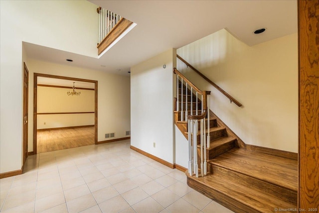 4665 Black Rock Tpke, Fairfield, CT 06824 - stairs with baseboards, tile patterned flooring, and a chandelier