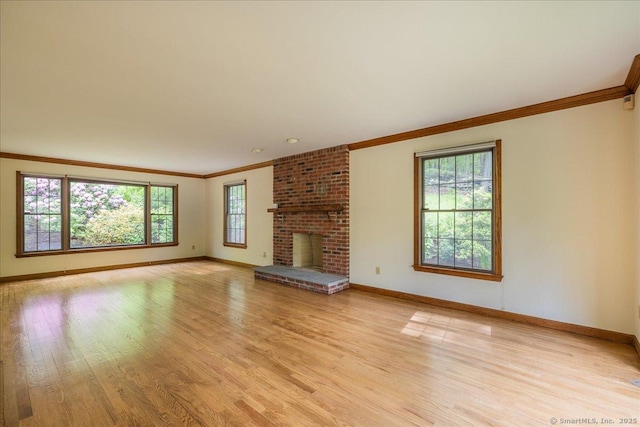 4665 Black Rock Tpke, Fairfield, CT 06824 - unfurnished living room featuring crown molding, baseboards, light wood-style floors, and a fireplace