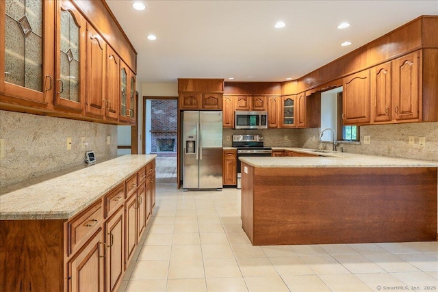 4665 Black Rock Tpke, Fairfield, CT 06824 - kitchen with appliances with stainless steel finishes, a peninsula, backsplash, brown cabinets, and recessed lighting