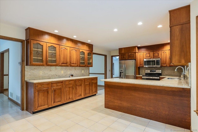 4665 Black Rock Tpke, Fairfield, CT 06824 - kitchen featuring appliances with stainless steel finishes, a sink, tasteful backsplash, brown cabinets, and recessed lighting