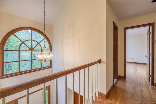 4665 Black Rock Tpke, Fairfield, CT 06824 - hallway featuring wood finished floors, a chandelier, baseboards, an upstairs landing, and vaulted ceiling