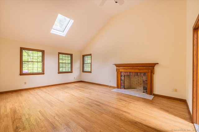 4665 Black Rock Tpke, Fairfield, CT 06824 - unfurnished living room with a skylight, a fireplace, plenty of natural light, light wood-type flooring, and high vaulted ceiling