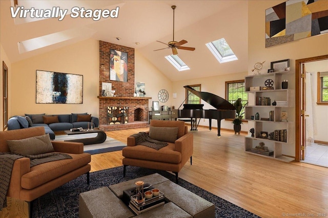 4665 Black Rock Tpke, Fairfield, CT 06824 - living area featuring a skylight, high vaulted ceiling, wood finished floors, a fireplace, and ceiling fan
