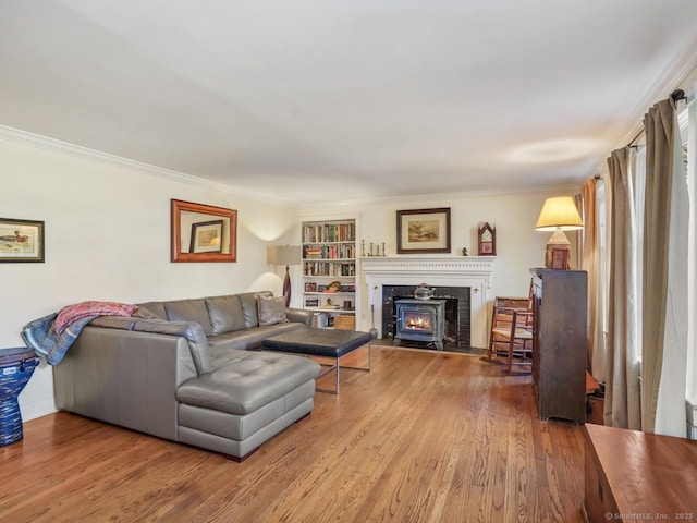 44 Meadow Ridge Dr, Easton, CT 06612 - living area with ornamental molding, wood finished floors, a warm lit fireplace, and built in features