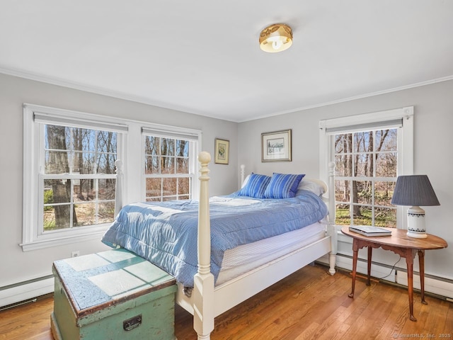 44 Meadow Ridge Dr, Easton, CT 06612 - bedroom with ornamental molding, wood finished floors, baseboard heating, and a baseboard heating unit