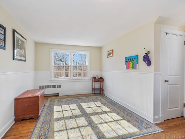 44 Meadow Ridge Dr, Easton, CT 06612 - spare room featuring radiator heating unit, a wainscoted wall, and wood finished floors