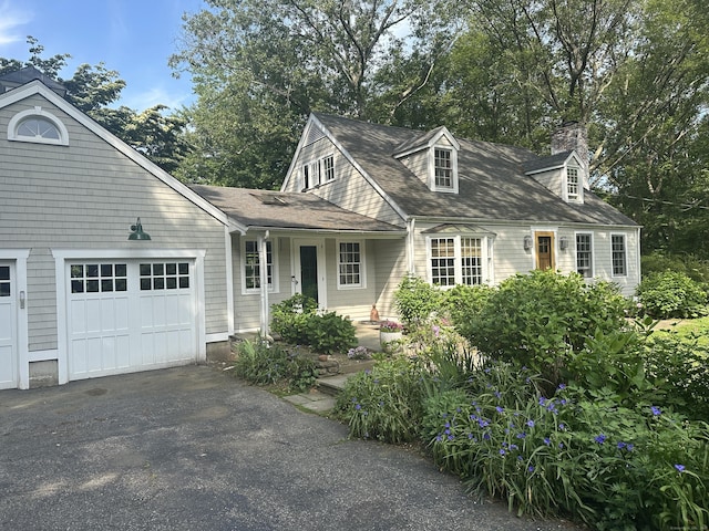 44 Meadow Ridge Dr, Easton, CT 06612 - view of front of property featuring a garage, a chimney, asphalt driveway, and roof with shingles