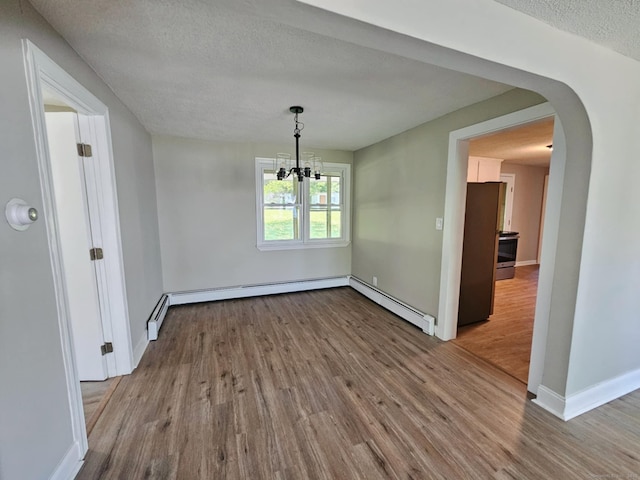 354 Clinton St, New Britain, CT 06053 - unfurnished dining area with wood finished floors, arched walkways, a chandelier, a textured ceiling, and baseboards