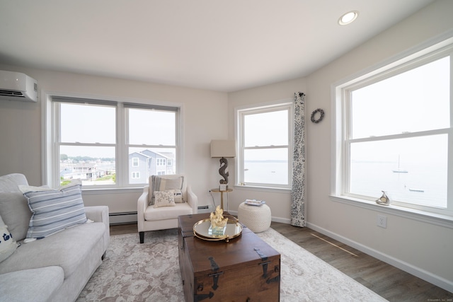 22 Shore Rd, East Lyme, CT 06357 - living room featuring a baseboard radiator, light wood-style flooring, an AC wall unit, healthy amount of natural light, and recessed lighting