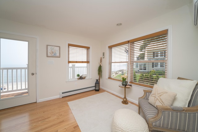 22 Shore Rd, East Lyme, CT 06357 - living area featuring baseboard heating, light wood-style flooring, and a water view