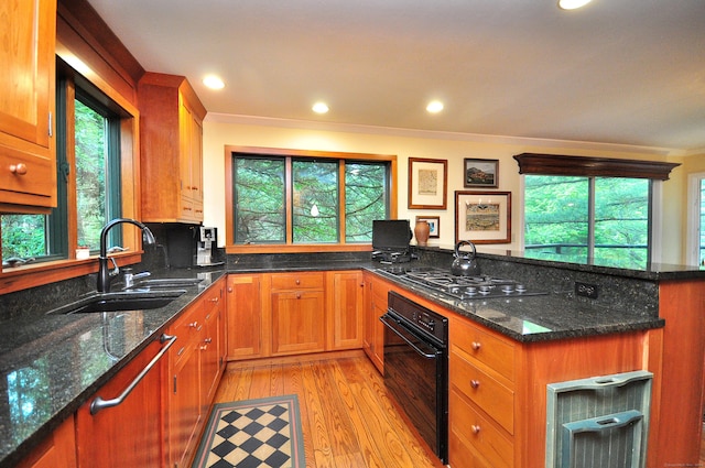 21 Bexley Ct, Goshen, CT 06756 - kitchen with black oven, a sink, stainless steel gas stovetop, crown molding, and light wood-type flooring