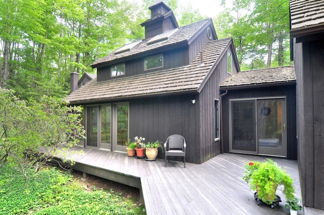 21 Bexley Ct, Goshen, CT 06756 - back of property featuring a wooden deck, a chimney, and french doors