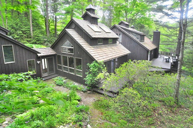 21 Bexley Ct, Goshen, CT 06756 - back of house with a wooden deck, a chimney, and a sunroom