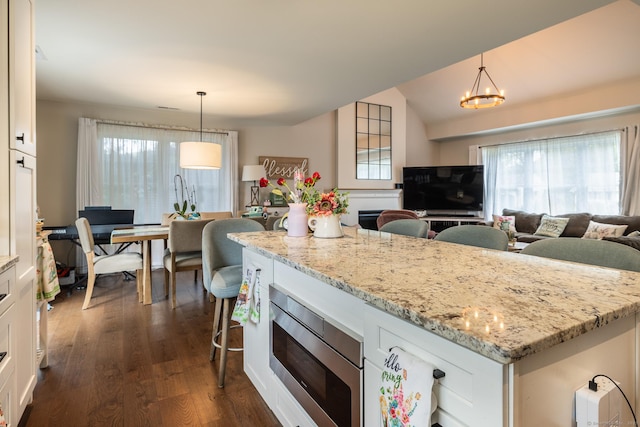 20 Jeffrey Ln, Southington, CT 06451 - kitchen with stainless steel microwave, healthy amount of natural light, dark wood-style floors, and white cabinetry