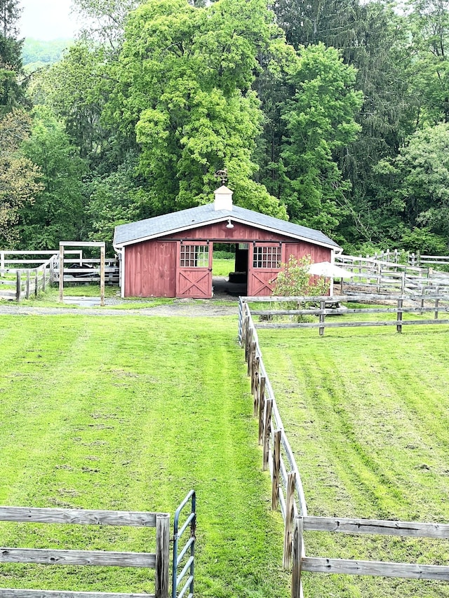 49 Warner Rd, Bridgewater, CT 06752 - view of grassy yard featuring an exterior structure, an outbuilding, and a forest view