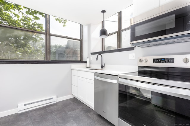 201 College St Unit 3, Middletown, CT 06457 - kitchen featuring stainless steel appliances, baseboard heating, a sink, white cabinets, and light countertops