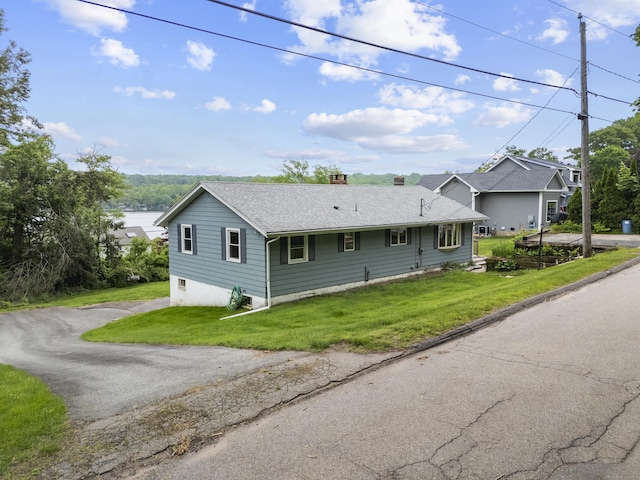 114 Wildwood Rd, East Haddam, CT 06415 - view of front of home with roof with shingles, a chimney, and a front yard