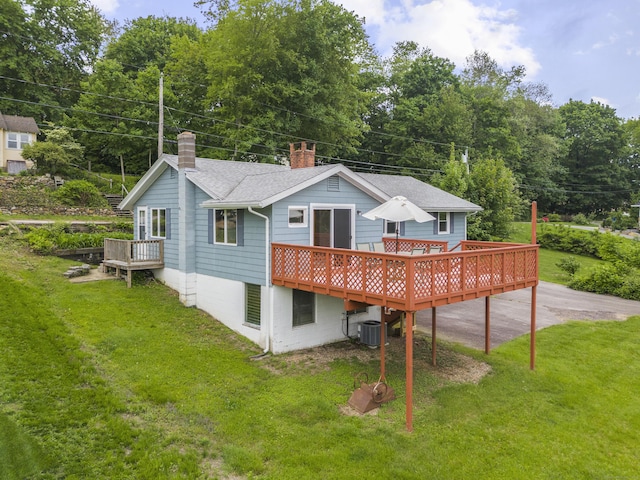 114 Wildwood Rd, East Haddam, CT 06415 - rear view of house with a chimney, a wooden deck, a yard, and central AC unit
