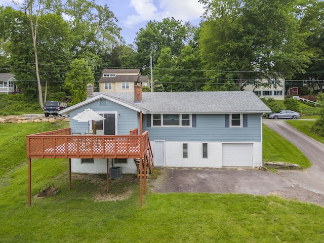 114 Wildwood Rd, East Haddam, CT 06415 - rear view of house featuring a chimney, asphalt driveway, a deck, central AC unit, and a yard