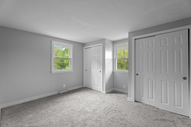 114 Wildwood Rd, East Haddam, CT 06415 - unfurnished bedroom with multiple closets, baseboards, and carpet flooring