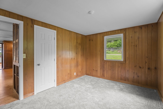 114 Wildwood Rd, East Haddam, CT 06415 - unfurnished bedroom featuring wood walls, baseboards, and carpet floors