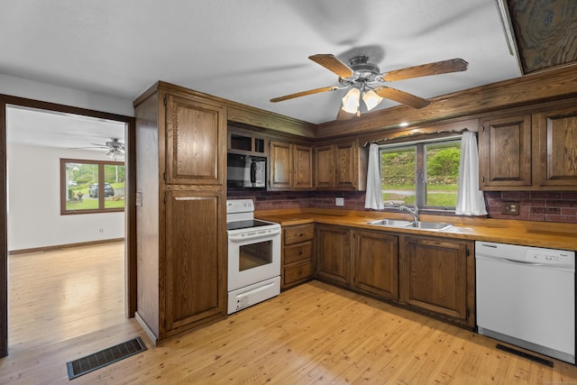 114 Wildwood Rd, East Haddam, CT 06415 - kitchen featuring white appliances, a sink, a ceiling fan, backsplash, and light wood finished floors