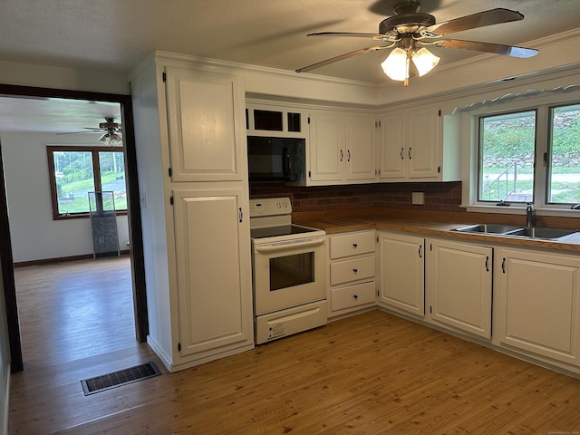 114 Wildwood Rd, East Haddam, CT 06415 - kitchen with electric range, black microwave, white cabinets, and crown molding