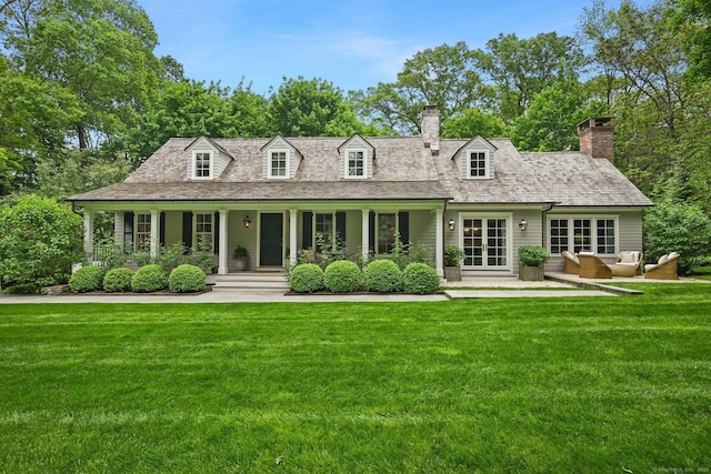 4 Budner Ln, Westport, CT 06880 - view of front of home with a front lawn, a chimney, an outdoor living space, and a porch