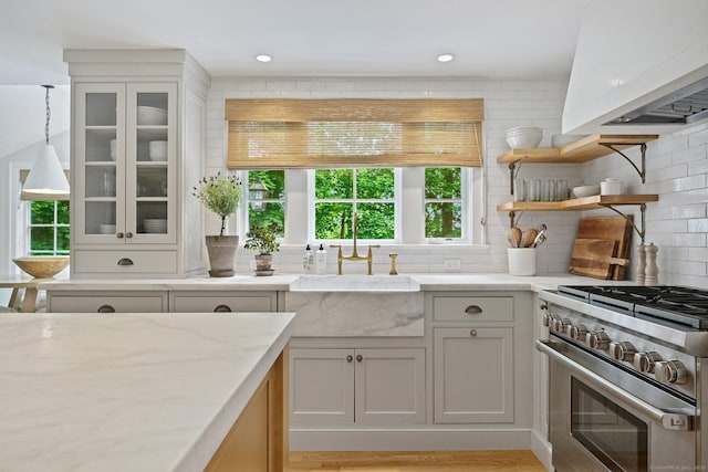 4 Budner Ln, Westport, CT 06880 - kitchen featuring high end range, plenty of natural light, decorative backsplash, premium range hood, and recessed lighting