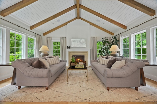 4 Budner Ln, Westport, CT 06880 - living area featuring light wood-type flooring, healthy amount of natural light, a warm lit fireplace, and wooden ceiling