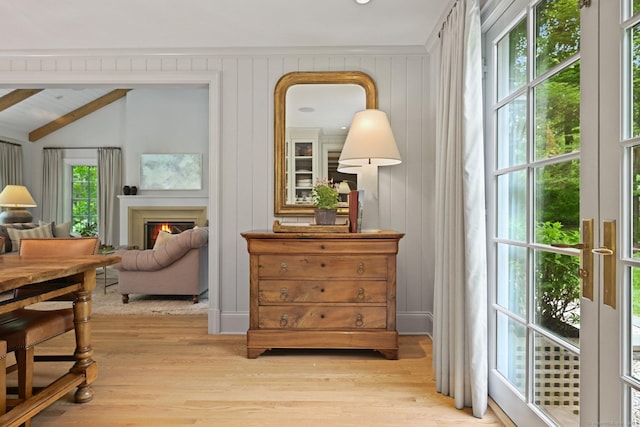 4 Budner Ln, Westport, CT 06880 - living area featuring light wood-type flooring, a warm lit fireplace, and beam ceiling