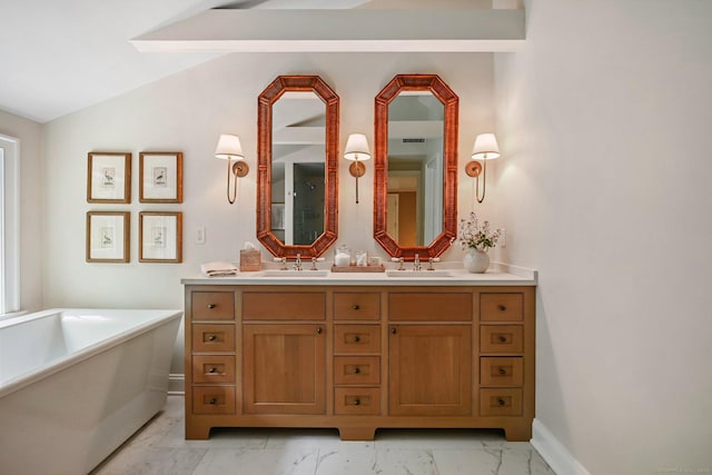 4 Budner Ln, Westport, CT 06880 - bathroom with marble finish flooring, a freestanding tub, double vanity, baseboards, and vaulted ceiling