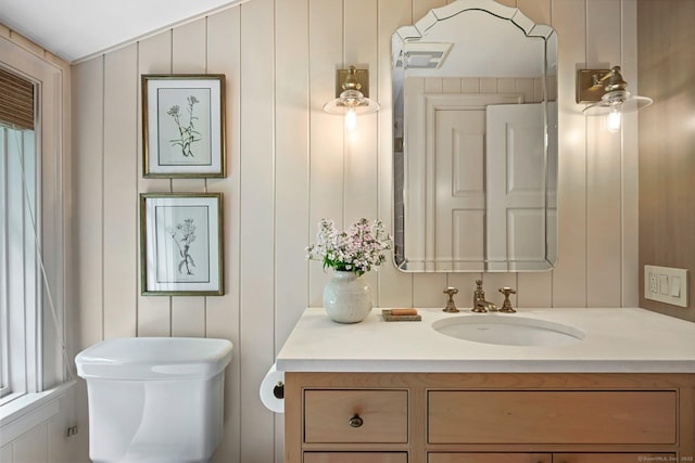 4 Budner Ln, Westport, CT 06880 - bathroom featuring vanity, toilet, and a decorative wall