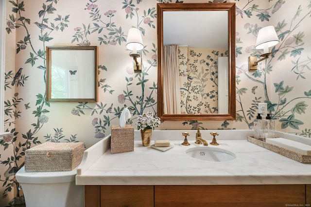 4 Budner Ln, Westport, CT 06880 - bathroom featuring wallpapered walls, vanity, and toilet