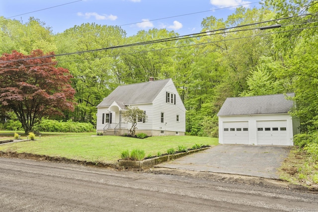 291 Maple Hill Rd, Naugatuck, CT 06770 - view of front of home featuring an outbuilding, a detached garage, a front lawn, a chimney, and a view of trees
