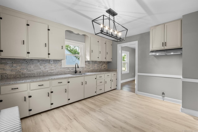 291 Maple Hill Rd, Naugatuck, CT 06770 - kitchen featuring a sink, decorative backsplash, healthy amount of natural light, and light countertops