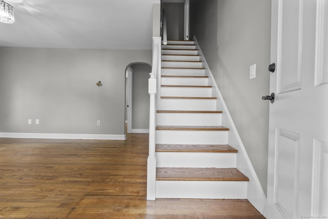 291 Maple Hill Rd, Naugatuck, CT 06770 - stairs featuring arched walkways, wood finished floors, and baseboards
