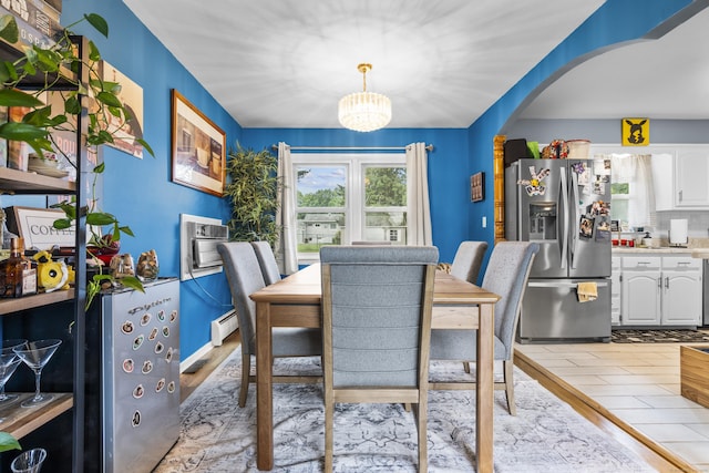 21 Cadwell Rd, Bloomfield, CT 06002 - dining space featuring arched walkways, a chandelier, wood finished floors, a wall mounted air conditioner, and a baseboard heating unit