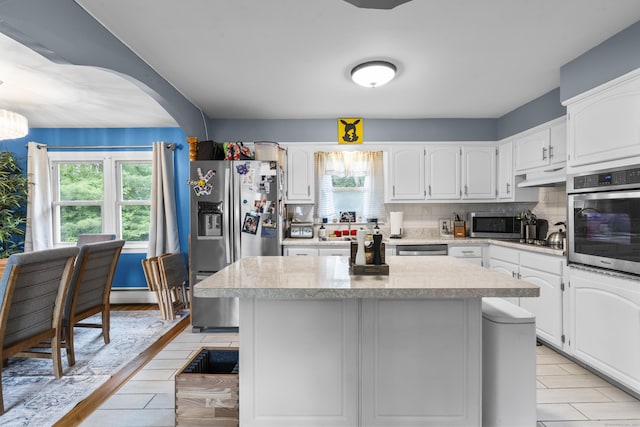 21 Cadwell Rd, Bloomfield, CT 06002 - kitchen with stainless steel appliances, light countertops, under cabinet range hood, and a center island