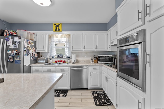 21 Cadwell Rd, Bloomfield, CT 06002 - kitchen with stainless steel appliances, light countertops, white cabinets, range hood, and tasteful backsplash