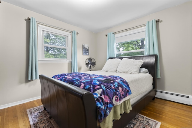 21 Cadwell Rd, Bloomfield, CT 06002 - bedroom featuring baseboard heating, multiple windows, and wood finished floors