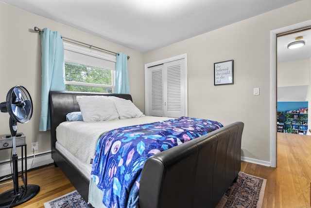 21 Cadwell Rd, Bloomfield, CT 06002 - bedroom featuring a closet, wood finished floors, and baseboard heating