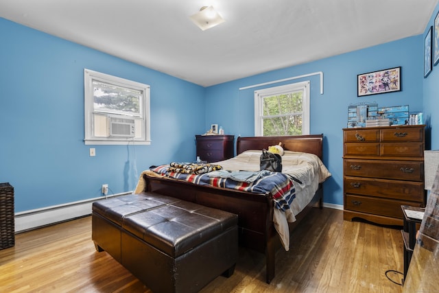 21 Cadwell Rd, Bloomfield, CT 06002 - bedroom with wood finished floors, baseboard heating, and cooling unit