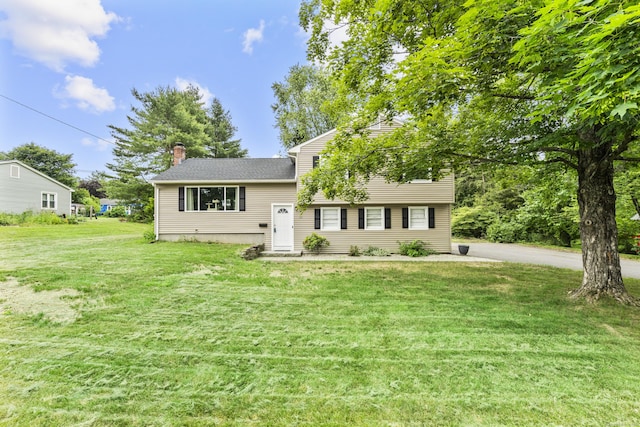 21 Cadwell Rd, Bloomfield, CT 06002 - tri-level home with a front lawn and a chimney