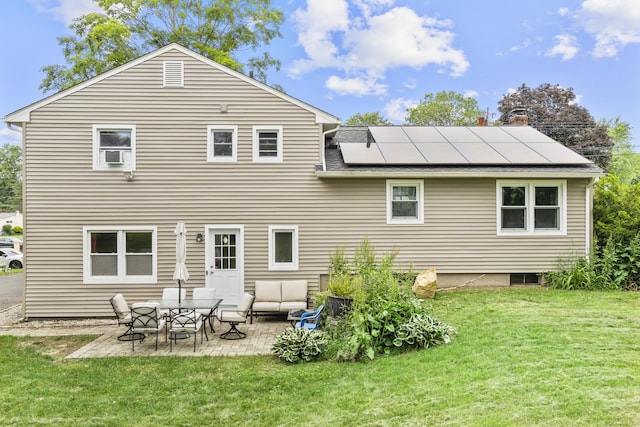 21 Cadwell Rd, Bloomfield, CT 06002 - back of property with roof mounted solar panels, a lawn, and a patio